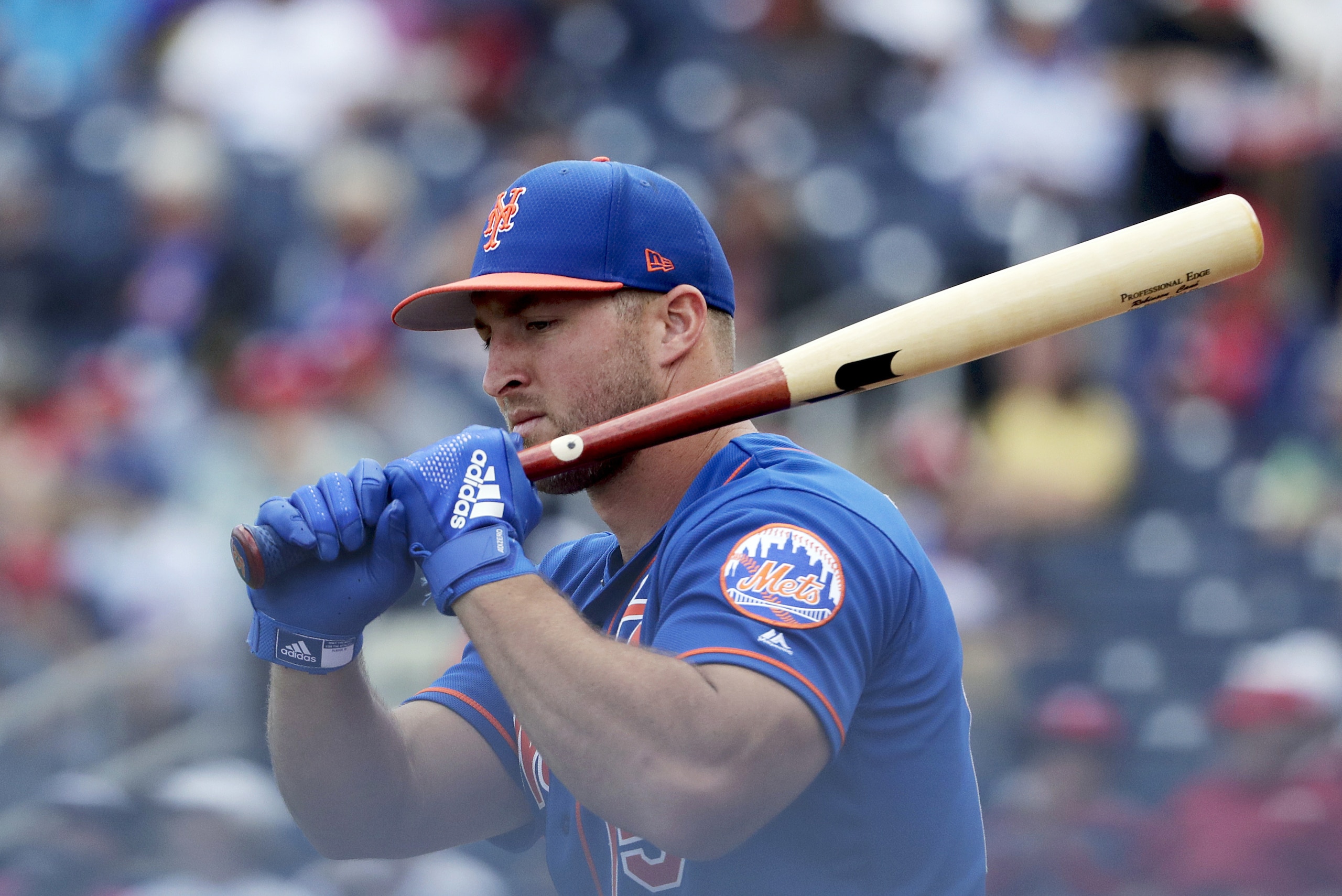 FILE - In this March 7, 2019, file photo, New York Mets' Tim Tebow loosens up before batting in an exhibition spring training baseball game against the Washington Nationals in West Palm Beach, Fla. Tebow is set to begin his third full season of minor league baseball. He was assigned to the Triple-A Syracuse Mets just over two weeks ago and opening day is Thursday, April 4, 2019. (AP Photo/Brynn Anderson, File)