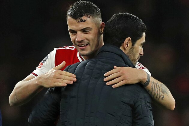 Arsenal's Swiss midfielder Granit Xhaka (L) and Arsenal's Spanish head coach Mikel Arteta (R) embrace on the pitch after the English FA Cup third round football match between Arsenal and Leeds United at The Emirates Stadium in London on January 6, 2020. - Arsenal won the game 1-0. (Photo by Adrian DENNIS / AFP) / RESTRICTED TO EDITORIAL USE. No use with unauthorized audio, video, data, fixture lists, club/league logos or 'live' services. Online in-match use limited to 120 images. An additional 40 images may be used in extra time. No video emulation. Social media in-match use limited to 120 images. An additional 40 images may be used in extra time. No use in betting publications, games or single club/league/player publications. / (Photo by ADRIAN DENNIS/AFP via Getty Images) Arsenal's Swiss midfielder Granit Xhaka (L) and Arsenal's Spanish head coach Mikel Arteta (R) embrace on the pitch after the English FA Cup third round football match between Arsenal and Leeds United at The Emirates Stadium in London on January 6, 2020. - Arsenal won the game 1-0. (Photo by Adrian DENNIS / AFP) / RESTRICTED TO EDITORIAL USE. No use with unauthorized audio, video, data, fixture lists, club/league logos or 'live' services. Online in-match use limited to 120 images. An additional 40 images may be used in extra time. No video emulation. Social media in-match use limited to 120 images. An additional 40 images may be used in extra time. No use in betting publications, games or single club/league/player publications. / (Photo by ADRIAN DENNIS/AFP via Getty Images)