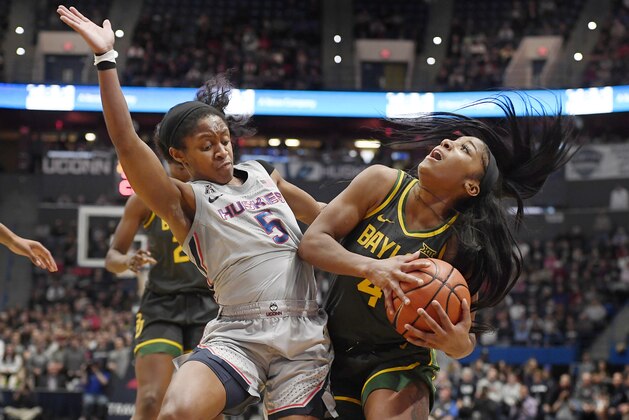 Connecticut's Crystal Dangerfield, left, fouls Baylor's Te'a Cooper during the first half of an NCAA college basketball game Thursday, Jan. 9, 2020, in Hartford, Conn. (AP Photo/Jessica Hill)