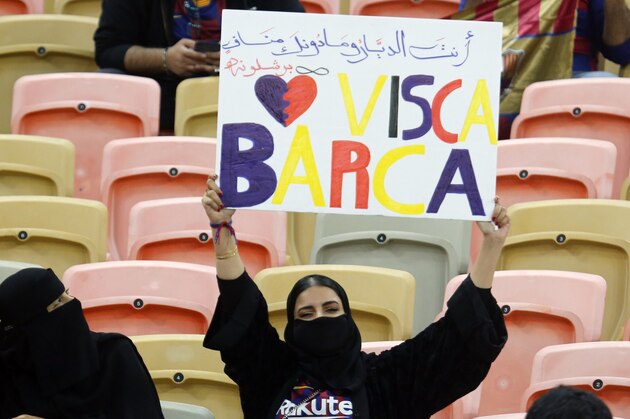 A Barcelona fan holds a banner ahead of the Spanish Super Cup semifinal soccer match between Barcelona and Atletico Madrid at King Abdullah stadium in Jiddah, Saudi Arabia, Thursday, Jan. 9, 2020. (AP Photo/Amr Nabil)