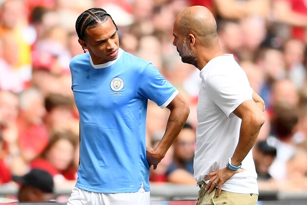 LONDON, ENGLAND - AUGUST 04: Pep Guardiola, Manager of Manchester City talks to Leroy Sane of Manchester City as he leaves the pitch with an injury during the FA Community Shield match between Liverpool and Manchester City at Wembley Stadium on August 04, 2019 in London, England. (Photo by Clive Mason/Getty Images)