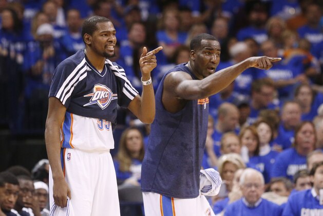 Oklahoma City Thunder forward Kevin Durant, left, and center Kendrick Perkins, right, gesture to their teammates during Game 1 of their Western Conference Semifinals NBA basketball playoff series against the Memphis Grizzlies in Oklahoma City, Sunday, May 5, 2013. Oklahoma City won 93-91. (AP Photo/Sue Ogrocki)