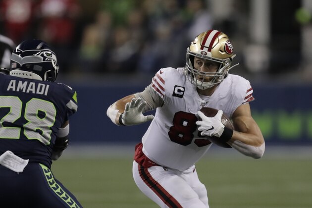 San Francisco 49ers tight end George Kittle (85) carries as Seattle Seahawks' Ugo Amadi approaches during the first half of an NFL football game, Sunday, Dec. 29, 2019, in Seattle. (AP Photo/Stephen Brashear)