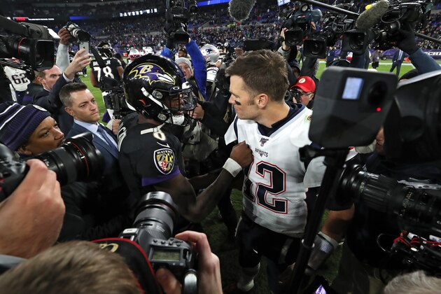 BALTIMORE, MARYLAND - NOVEMBER 03: Quarterback Lamar Jackson #8 of the Baltimore Ravens and quarterback Tom Brady #12 of the New England Patriots talk after the Ravens defeated the Patriots at M&T Bank Stadium on November 3, 2019 in Baltimore, Maryland. (Photo by Todd Olszewski/Getty Images)