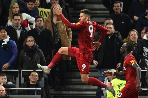 Liverpool's Brazilian midfielder Roberto Firmino (L) celebrates scoring the opening goal during the English Premier League football match between Tottenham Hotspur and Liverpool at Tottenham Hotspur Stadium in London, on January 11, 2020. (Photo by Glyn KIRK / AFP) / RESTRICTED TO EDITORIAL USE. No use with unauthorized audio, video, data, fixture lists, club/league logos or 'live' services. Online in-match use limited to 120 images. An additional 40 images may be used in extra time. No video emulation. Social media in-match use limited to 120 images. An additional 40 images may be used in extra time. No use in betting publications, games or single club/league/player publications. /  (Photo by GLYN KIRK/AFP via Getty Images)