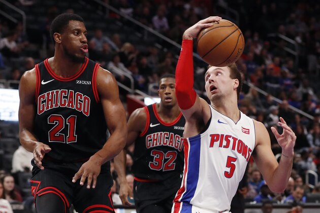 Detroit Pistons guard Luke Kennard (5) looks to pass around the defense of Chicago Bulls forward Thaddeus Young (21) during the first half of an NBA basketball game, Saturday, Dec. 21, 2019, in Detroit. (AP Photo/Carlos Osorio)