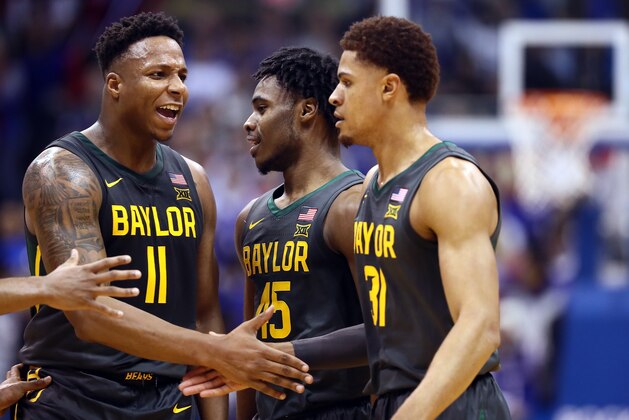 LAWRENCE, KANSAS - JANUARY 11:  Mark Vital #11 and Davion Mitchell #45 of the Baylor Bears congratulate MaCio Teague #31 after a basket during the game against the Kansas Jayhawks at Allen Fieldhouse on January 11, 2020 in Lawrence, Kansas. (Photo by Jamie Squire/Getty Images)