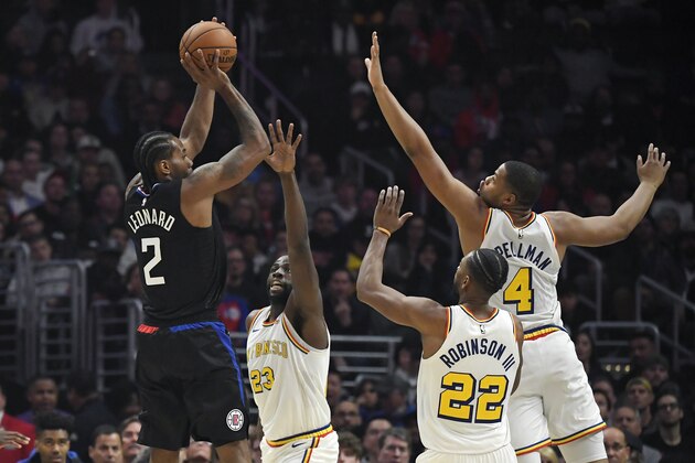 Los Angeles Clippers forward Kawhi Leonard, left, shoots as Golden State Warriors forward Draymond Green, second from left, Glenn Robinson III and forward Omari Spellman defend during the second half of an NBA basketball game Friday, Jan. 10, 2020, in Los Angeles. The Clippers won 109-100. (AP Photo/Mark J. Terrill)