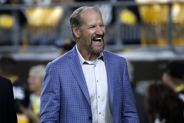 Former head coach of the Pittsburgh Steelers Bill Cowher, center, walks on the field at Heinz Field before an NFL football game between the Pittsburgh Steelers and the Cincinnati Bengals in Pittsburgh, Monday, Sept. 30, 2019. (AP Photo/Don Wright)