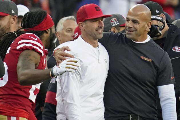 San Francisco 49ers head coach Kyle Shanahan, center, is greeted by with cornerback Richard Sherman, left, and defensive coordinator Robert Saleh, right, in the final minutes of the second half of an NFL divisional playoff football game against the Minnesota Vikings, Saturday, Jan. 11, 2020, in Santa Clara, Calif. The 49ers won 27-10. (AP Photo/Tony Avelar)