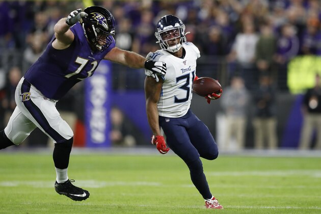 Tennessee Titans free safety Kevin Byard (31) moves past Baltimore Ravens offensive guard Marshal Yanda (73) after an interception during the first half an NFL divisional playoff football game, Saturday, Jan. 11, 2020, in Baltimore. (AP Photo/Julio Cortez)