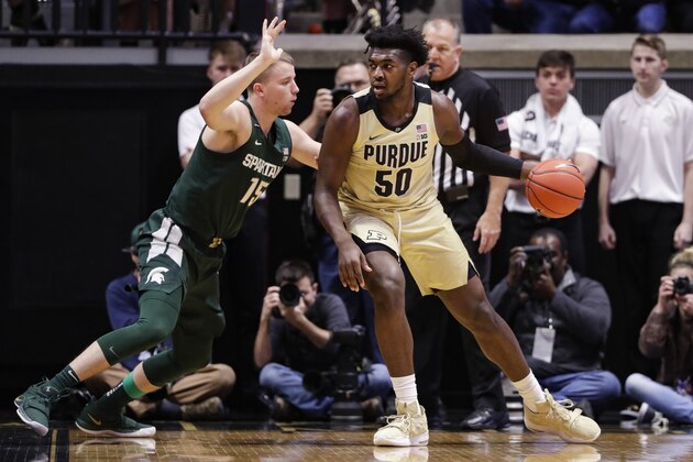 Purdue forward Trevion Williams (50) drives on Michigan State forward Thomas Kithier (15) during the first half of an NCAA college basketball game in West Lafayette, Ind., Sunday, Jan. 12, 2020. (AP Photo/Michael Conroy)