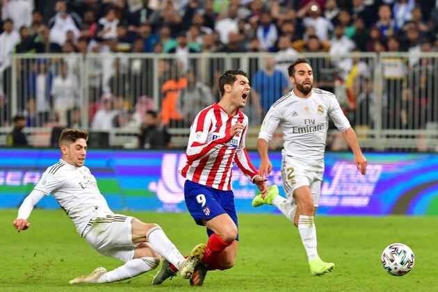 Real Madrid's Uruguayan midfielder Federico Valverde (L) fouls Atletico Madrid's Spanish forward Alvaro Morata (C) during the Spanish Super Cup final between Real Madrid and Atletico Madrid on January 12, 2020, at the King Abdullah Sports City in the Saudi Arabian port city of Jeddah. (Photo by Giuseppe CACACE / AFP) (Photo by GIUSEPPE CACACE/AFP via Getty Images)
