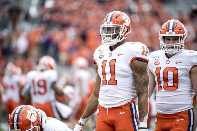 Clemson linebacker Isaiah Simmons (11) and linebacker Baylon Spector (10) warm up before an NCAA college football game against South Carolina Saturday, Nov. 30, 2019, in Columbia, S.C. Clemson defeated South Carolina 38-3. (AP Photo/Sean Rayford)