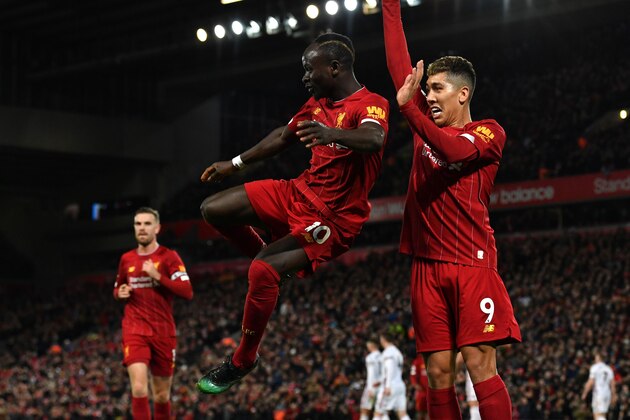 Liverpool's Senegalese striker Sadio Mane (L) celebrates with Liverpool's Brazilian midfielder Roberto Firmino after he scores his team's second goal during the English Premier League football match between Liverpool and Sheffield United at Anfield in Liverpool, north west England on January 2, 2020. (Photo by Paul ELLIS / AFP) / RESTRICTED TO EDITORIAL USE. No use with unauthorized audio, video, data, fixture lists, club/league logos or 'live' services. Online in-match use limited to 120 images. An additional 40 images may be used in extra time. No video emulation. Social media in-match use limited to 120 images. An additional 40 images may be used in extra time. No use in betting publications, games or single club/league/player publications. /  (Photo by PAUL ELLIS/AFP via Getty Images)