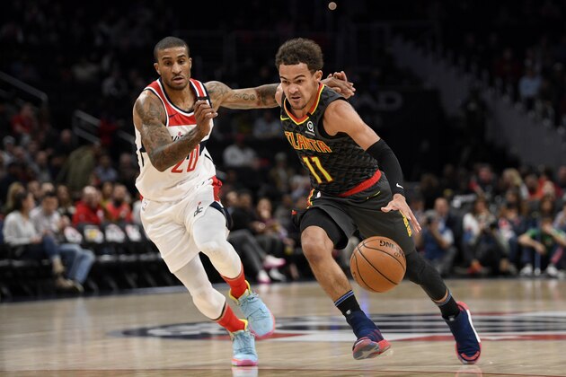 Atlanta Hawks guard Trae Young (11) drives to the basket past Washington Wizards guard Gary Payton II (20) during the first half of an NBA basketball game, Friday, Jan. 10, 2020, in Washington. (AP Photo/Nick Wass)