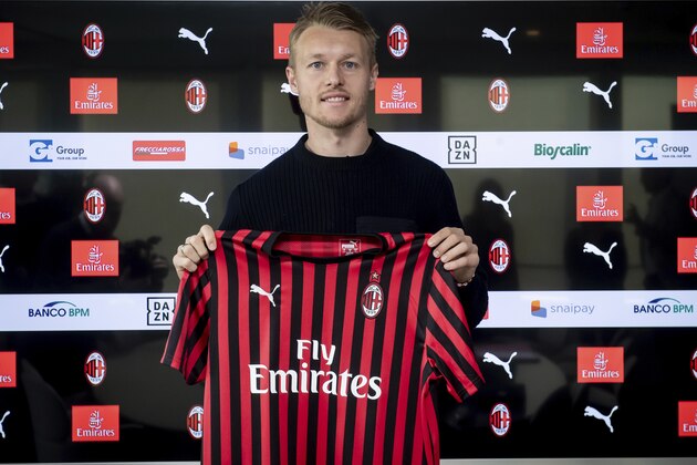 Simon Kjaer holds the AC Milan soccer club jersey as he poses for photographers during his official presentation at he club headquarters in Milan, Italy, Monday, Jan. 13, 2020. (Claudio Furlan/LaPresse via AP)
