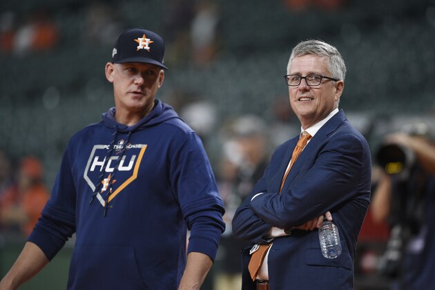 Houston Astros manager AJ Hinch, left, and general manager Jeff Luhnow, right, before Game 2 of a best-of-five American League Division Series baseball game against the Tampa Bay Rays in Houston, Saturday, Oct. 5, 2019. (AP Photo/Eric Christian Smith)