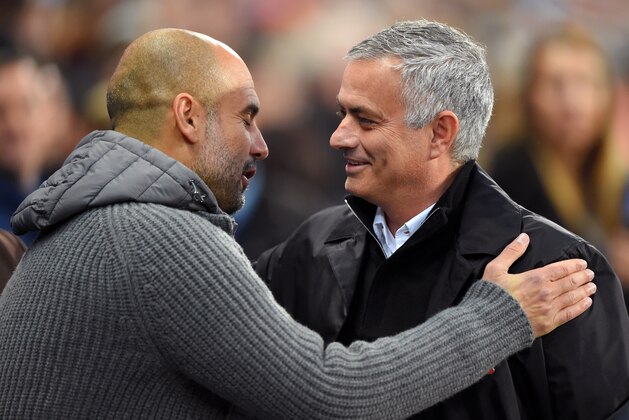 MANCHESTER, ENGLAND - NOVEMBER 11:  Josep Guardiola, Manager of Manchester City and Jose Mourinho, Manager of Manchester United embrace prior to the Premier League match between Manchester City and Manchester United at Etihad Stadium on November 11, 2018 in Manchester, United Kingdom.  (Photo by Mike Hewitt/Getty Images)