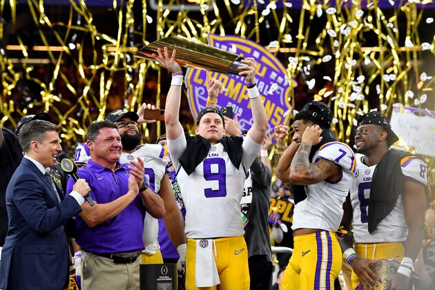 NEW ORLEANS, LOUISIANA - JANUARY 13: Joe Burrow of the LSU Tigers raises the National Championship Trophy with Ed Orgeron, Grant Delpit #7, and Patrick Queen #8 after the College Football Playoff National Championship game at the Mercedes Benz Superdome on January 13, 2020 in New Orleans, Louisiana. The LSU Tigers topped the Clemson Tigers, 42-25. (Photo by Alika Jenner/Getty Images)