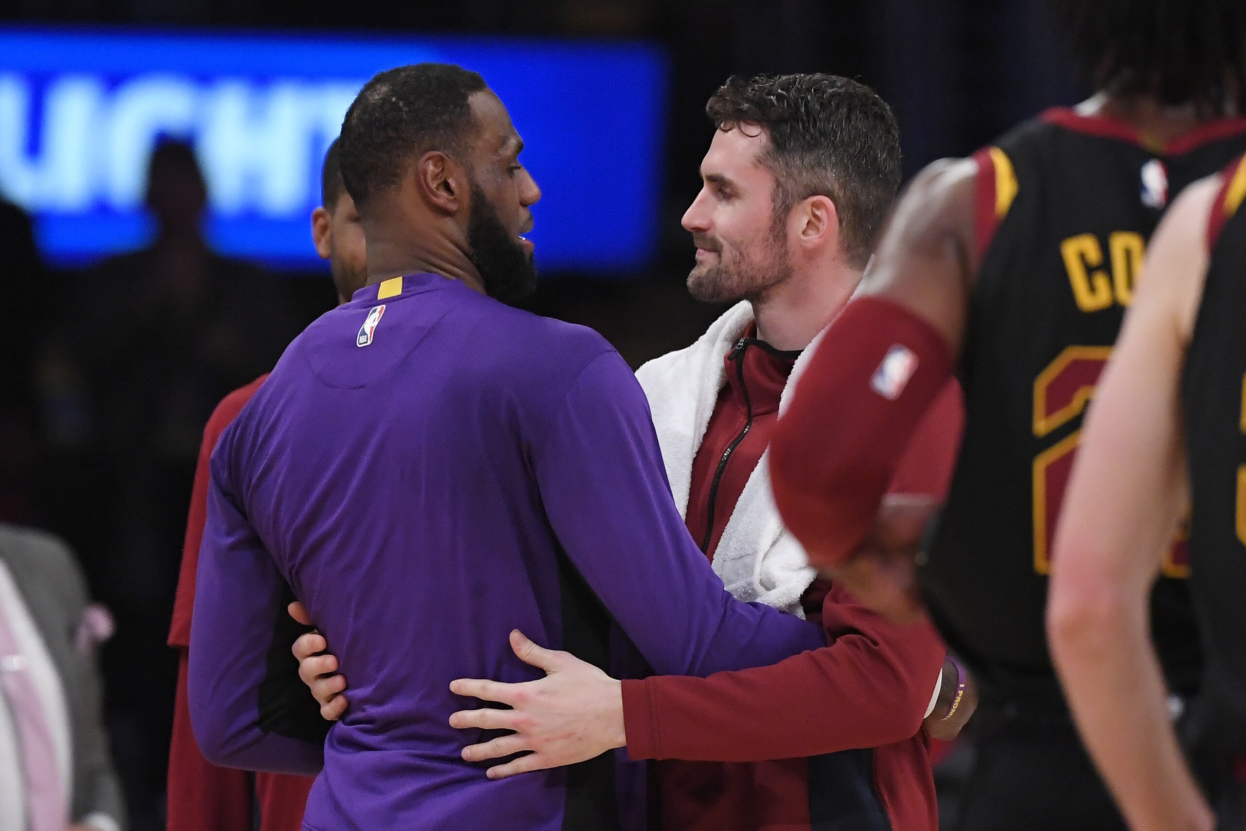 Los Angeles Lakers forward LeBron James, left, and Cleveland Cavaliers forward Kevin Love embrace after the Lakers defeated the Cavaliers 128-99 in an NBA basketball game, Monday, Jan. 13, 2020, in Los Angeles. (AP Photo/Mark J. Terrill)