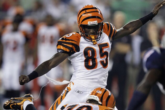 Cincinnati Bengals wide receiver Chad Ochocinco (85) kicks the extra point after a touchdown by teammate Chris Henry in the second quarter of their preseason NFL football game in Foxborough, Mass., Thursday Aug. 20, 2009. Holding is punter Kevin Huber. (AP Photo/Charles Krupa)