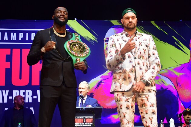 Boxers Deontay Wilder (L) and Tyson Fury (R) gesture on arrival for a press conference in Los Angeles, California on January 13, 2020 ahead of their re-match fight in Las Vegas on February 22. (Photo by Frederic J. BROWN / AFP) (Photo by FREDERIC J. BROWN/AFP via Getty Images)