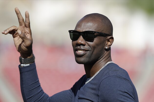 Former NFL wide receiver Terrell Owens waves to fans an NFL football game between the Tampa Bay Buccaneers and the Indianapolis Colts Sunday, Dec. 8, 2019, in Tampa, Fla. (AP Photo/Chris O'Meara)