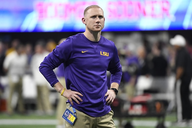 LSU offensive coach Joe Brady watches his team warm up before the first half of the Peach Bowl NCAA semifinal college football playoff game between LSU and Oklahoma, Saturday, Dec. 28, 2019, in Atlanta. (AP Photo/Danny Karnik)