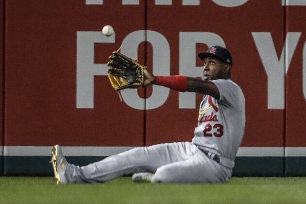 St. Louis Cardinals' Marcell Ozuna can't catch a ball hit by Washington Nationals' Anthony Rendon during the third inning of Game 3 of the baseball National League Championship Series Monday, Oct. 14, 2019, in Washington. Adam Eaton scored on the play. (AP Photo/Jeff Roberson)