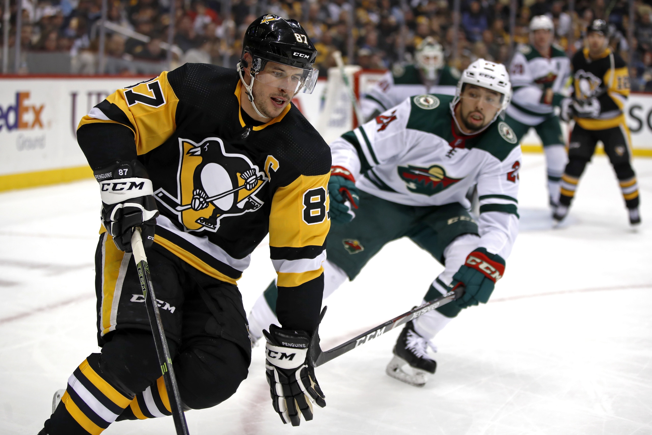 Pittsburgh Penguins' Sidney Crosby (87) works the puck in the corner with Minnesota Wild's Matt Dumba (24) defending during the second period of an NHL hockey game in Pittsburgh, Tuesday, Jan. 14, 2020. (AP Photo/Gene J. Puskar) Pittsburgh Penguins' Sidney Crosby (87) works the puck in the corner with Minnesota Wild's Matt Dumba (24) defending during the second period of an NHL hockey game in Pittsburgh, Tuesday, Jan. 14, 2020. (AP Photo/Gene J. Puskar)