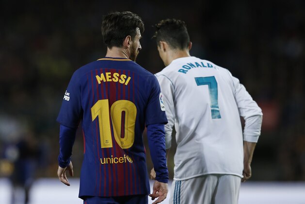 Barcelona's Lionel Messi, left and Real Madrid's Cristiano Ronaldo walk back to take positions during a Spanish La Liga soccer match between Barcelona and Real Madrid, dubbed 'el clasico', at the Camp Nou stadium in Barcelona, Spain, Sunday, May 6, 2018. (AP Photo/Manu Fernandez)