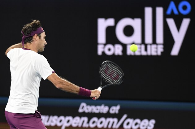 Roger Federer of Switzerland hits a return as he and the world's top players play in the Rally for Relief charity tennis match in support of the victims of the Australian bushfires, in Melbourne of January 15, 2020, ahead of the Australian Open tennis tournament. (Photo by WILLIAM WEST / AFP) / -- IMAGE RESTRICTED TO EDITORIAL USE - STRICTLY NO COMMERCIAL USE -- (Photo by WILLIAM WEST/AFP via Getty Images)