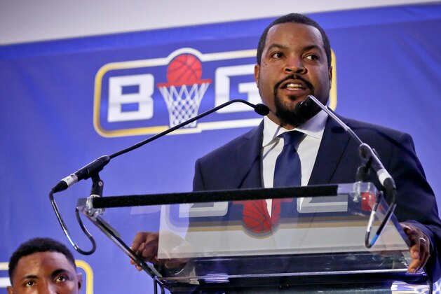 FILE - In this Jan. 11, 2017, file photo, former NBA player and players union deputy Roger Mason, left, listens as entertainer Ice Cube, right, announces the launch of the BIG3, a new 3-on-3 professional basketball league, in New York. For his league of former NBA players that debuts Sunday, the actor-entertainer insisted the competition be serious, a proper representation of a form of basketball that's so popular that it's ticketed for the next Olympics. (AP Photo/Bebeto Matthews, File)
