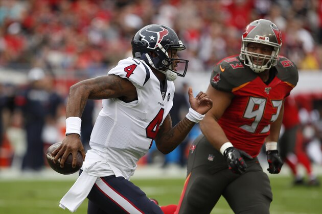 Houston Texans quarterback Deshaun Watson (4) scrambles in front of Tampa Bay Buccaneers nose tackle Ndamukong Suh (93) during the first half of an NFL football game Saturday, Dec. 21, 2019, in Tampa, Fla. (AP Photo/Mark LoMoglio)