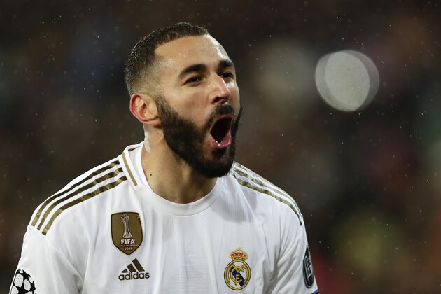 Real Madrid's Karim Benzema celebrates after scoring his side's opening goal during a Champions League soccer match Group A between Real Madrid and Paris Saint Germain at the Santiago Bernabeu stadium in Madrid, Spain, Tuesday, Nov. 26, 2019. (AP Photo/Manu Fernandez)
