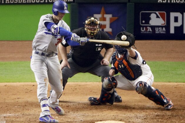 Los Angeles Dodgers' Cody Bellinger hits a triple against the Houston Astros during the seventh inning of Game 5 of baseball's World Series Sunday, Oct. 29, 2017, in Houston. (AP Photo/Charlie Riedel)