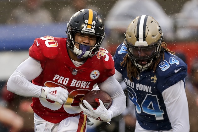 ORLANDO, FL - JANUARY 27: Runningback James Conner #30 of the Pittsburgh Steelers from the AFC Team avoids being tackled by Defensive End Cameron Jordan #94 of the New Orleans Saints from the NFC Team during the NFL Pro Bowl Game at Camping World Stadium on January 27, 2019 in Orlando, Florida. The AFC defeated the NFC 26 to 7. (Photo by Don Juan Moore/Getty Images)