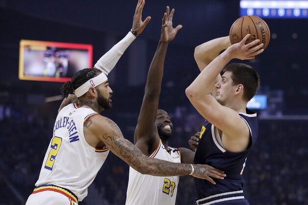 Denver Nuggets' Nikola Jokic, right, looks to pass the ball away from Golden State Warriors' Willie Cauley-Stein (2) and Draymond Green during the first half of an NBA basketball game Thursday, Jan. 16, 2020, in San Francisco. (AP Photo/Ben Margot)