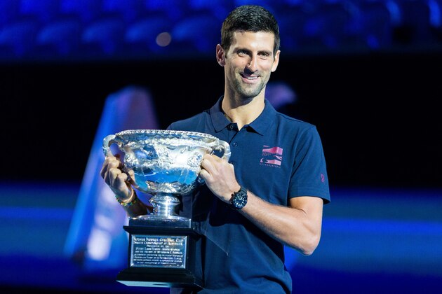 Novak Djokovic of Serbia poses with the men's singles championship trophy during the draw announcement of the Australian Open tennis tournament in Melbourne on January 16, 2020. (Photo by ASANKA BRENDON RATNAYAKE / AFP) / IMAGE RESTRICTED TO EDITORIAL USE - STRICTLY NO COMMERCIAL USE (Photo by ASANKA BRENDON RATNAYAKE/AFP via Getty Images)