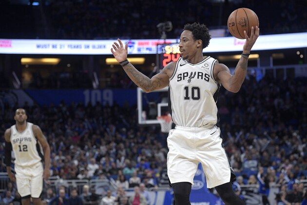 San Antonio Spurs forward DeMar DeRozan (10) looks to pass the ball in front of forward LaMarcus Aldridge (12) during the second half of an NBA basketball game against the Orlando Magic Friday, Nov. 15, 2019, in Orlando, Fla. (AP Photo/Phelan M. Ebenhack)