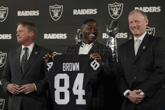 Oakland Raiders wide receiver Antonio Brown, center, holds his jersey beside coach Jon Gruden, left, and general manager Mike Mayock during an NFL football news conference Wednesday, March 13, 2019, in Alameda, Calif. (AP Photo/Ben Margot)