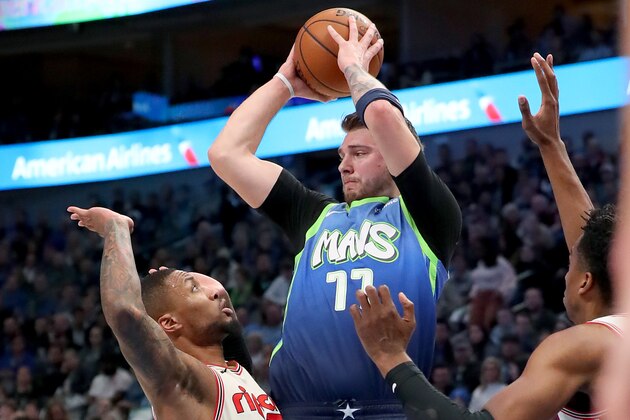 DALLAS, TEXAS - JANUARY 17: Luka Doncic #77 of the Dallas Mavericks passes the ball against Damian Lillard #0 of the Portland Trail Blazers and Hassan Whiteside #21 of the Portland Trail Blazers in the first period at American Airlines Center on January 17, 2020 in Dallas, Texas. NOTE TO USER: User expressly acknowledges and agrees that, by downloading and or using this photograph, User is consenting to the terms and conditions of the Getty Images License Agreement. (Photo by Tom Pennington/Getty Images) DALLAS, TEXAS - JANUARY 17: Luka Doncic #77 of the Dallas Mavericks passes the ball against Damian Lillard #0 of the Portland Trail Blazers and Hassan Whiteside #21 of the Portland Trail Blazers in the first period at American Airlines Center on January 17, 2020 in Dallas, Texas. NOTE TO USER: User expressly acknowledges and agrees that, by downloading and or using this photograph, User is consenting to the terms and conditions of the Getty Images License Agreement. (Photo by Tom Pennington/Getty Images)