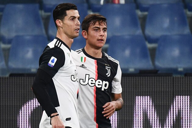 Juventus' Argentine forward Paulo Dybala (C) celebrates with Juventus' Portuguese forward Cristiano Ronaldo after opening the scoring during the Italian Serie A football match Sampdoria vs Juventus on December 18, 2019 at the Luigi-Ferraris stadium in Genoa. (Photo by Marco Bertorello / AFP) (Photo by MARCO BERTORELLO/AFP via Getty Images)