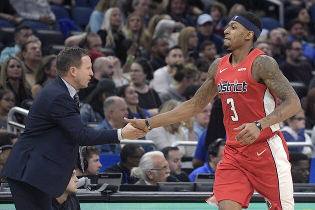 Washington Wizards guard Bradley Beal (3) is congratulated by head coach Scott Brooks after scoring a three-point basket during the second half of an NBA basketball game against the Orlando Magic, Friday, Jan. 25, 2019, in Orlando, Fla. (AP Photo/Phelan M. Ebenhack)