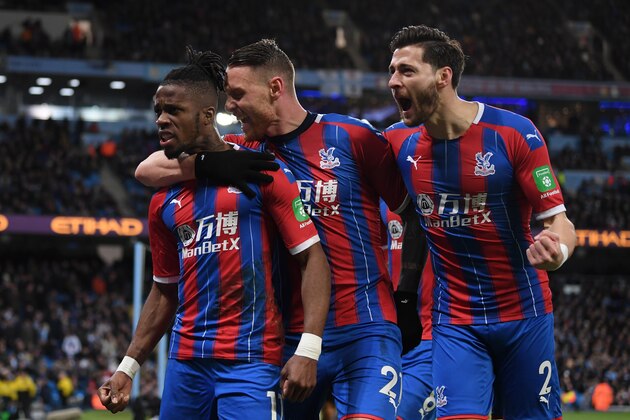 MANCHESTER, ENGLAND - JANUARY 18: Wilfried Zaha, Connor Wickham and Joel Ward of Crystal Palace celebrate after Fernandinho of Manchester City (not pictured) scored an own-goal which resulted in the second goal for Crystal Palace during the Premier League match between Manchester City and Crystal Palace at Etihad Stadium on January 18, 2020 in Manchester, United Kingdom. (Photo by Michael Regan/Getty Images)