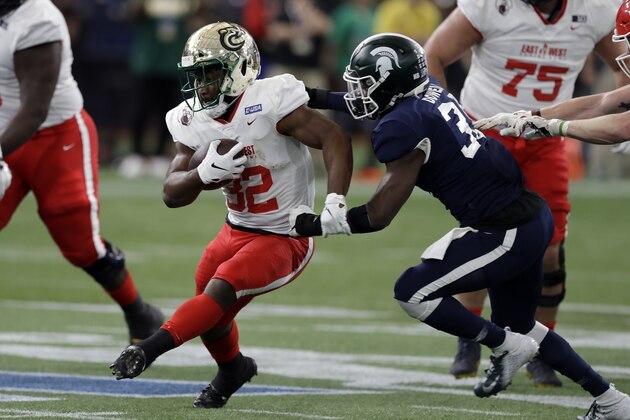 East running back Benny LeMay, of Charlotte, (32) gets past West safety David Dowell, of Michigan State, (36) on a run during the first half of the East West Shrine football game Saturday, Jan. 18, 2020, in St. Petersburg, Fla. (AP Photo/Chris O'Meara)
