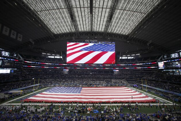 The American flag is displayed on the field before the NCAA Cotton Bowl college football game between Penn State and Memphis in Arlington, Texas, Saturday, Dec. 28, 2019. (AP Photo/Roger Steinman)