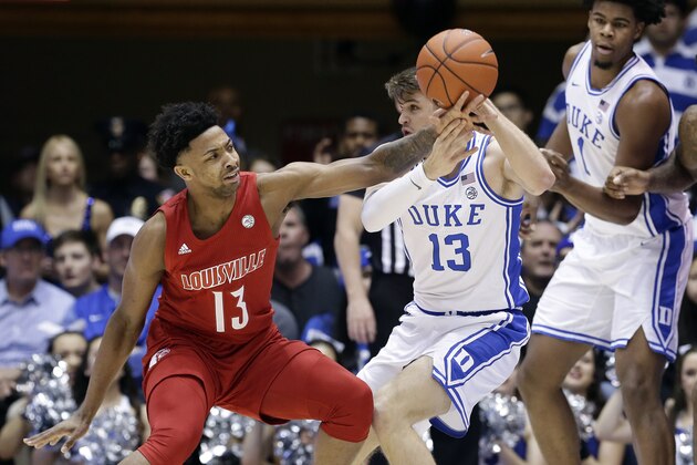Louisville guard David Johnson (13) reaches for the ball while Duke forward Joey Baker (13) looks to pass it during the first half of an NCAA college basketball game in Durham, N.C., Saturday, Jan. 18, 2020. (AP Photo/Gerry Broome)