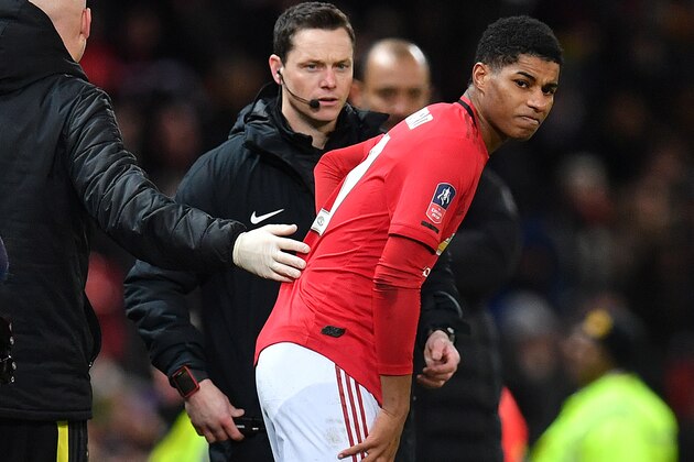 Manchester United's English striker Marcus Rashford (C) reacts after seeming to pick up an injury during the English FA Cup third round-replay football match between Manchester United and Wolverhampton Wanderers at Old Trafford in Manchester, north west England, on January 15, 2020. (Photo by Paul ELLIS / AFP) / RESTRICTED TO EDITORIAL USE. No use with unauthorized audio, video, data, fixture lists, club/league logos or 'live' services. Online in-match use limited to 120 images. An additional 40 images may be used in extra time. No video emulation. Social media in-match use limited to 120 images. An additional 40 images may be used in extra time. No use in betting publications, games or single club/league/player publications. /  (Photo by PAUL ELLIS/AFP via Getty Images)